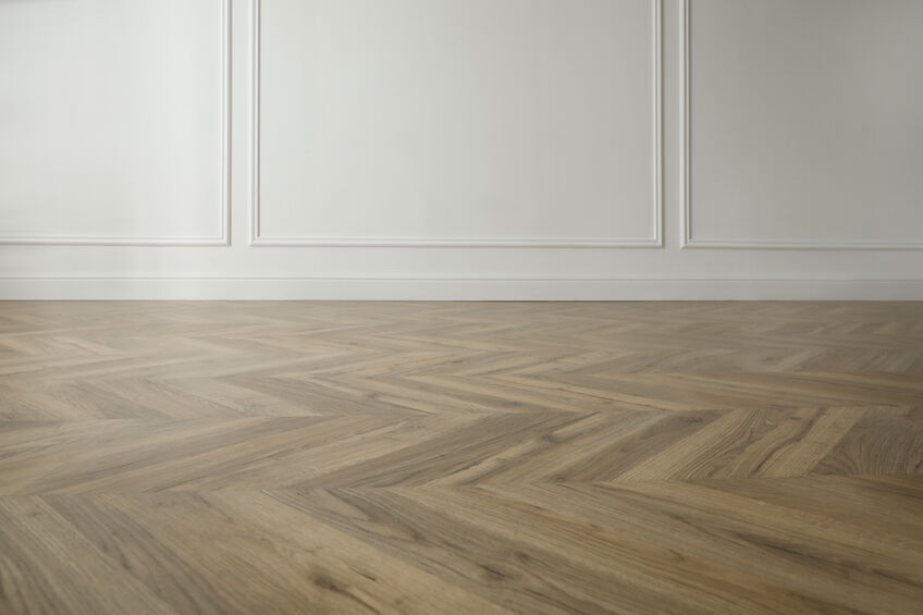 Parquet floor in light spacious empty room