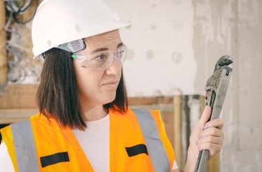 woman holding wrench