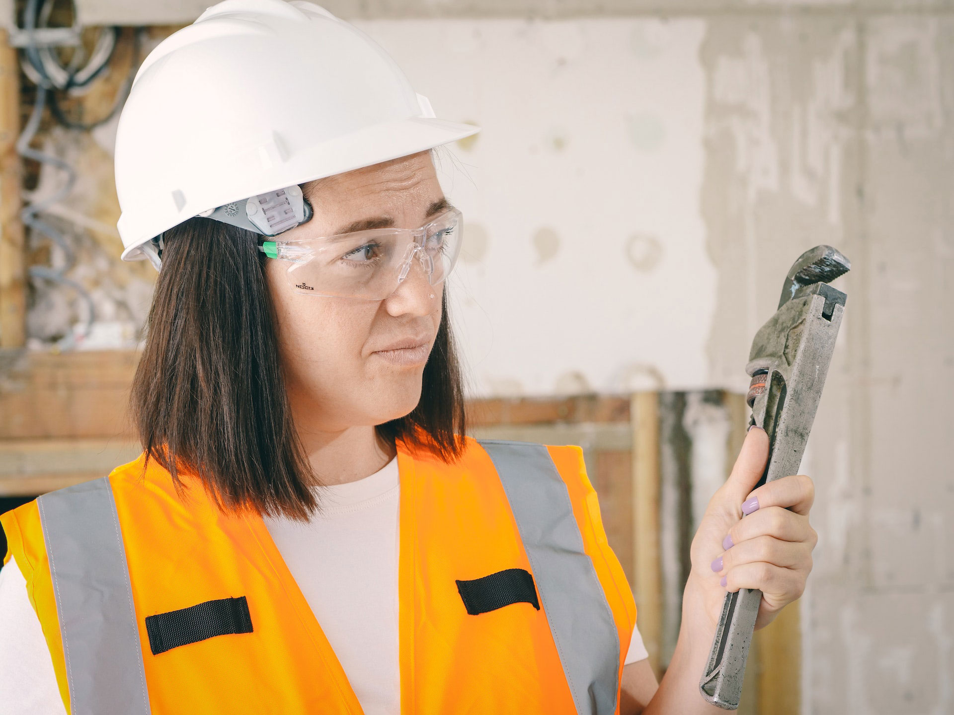 woman holding wrench