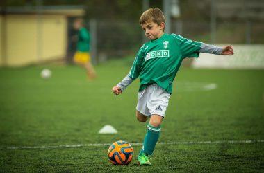 child playin football