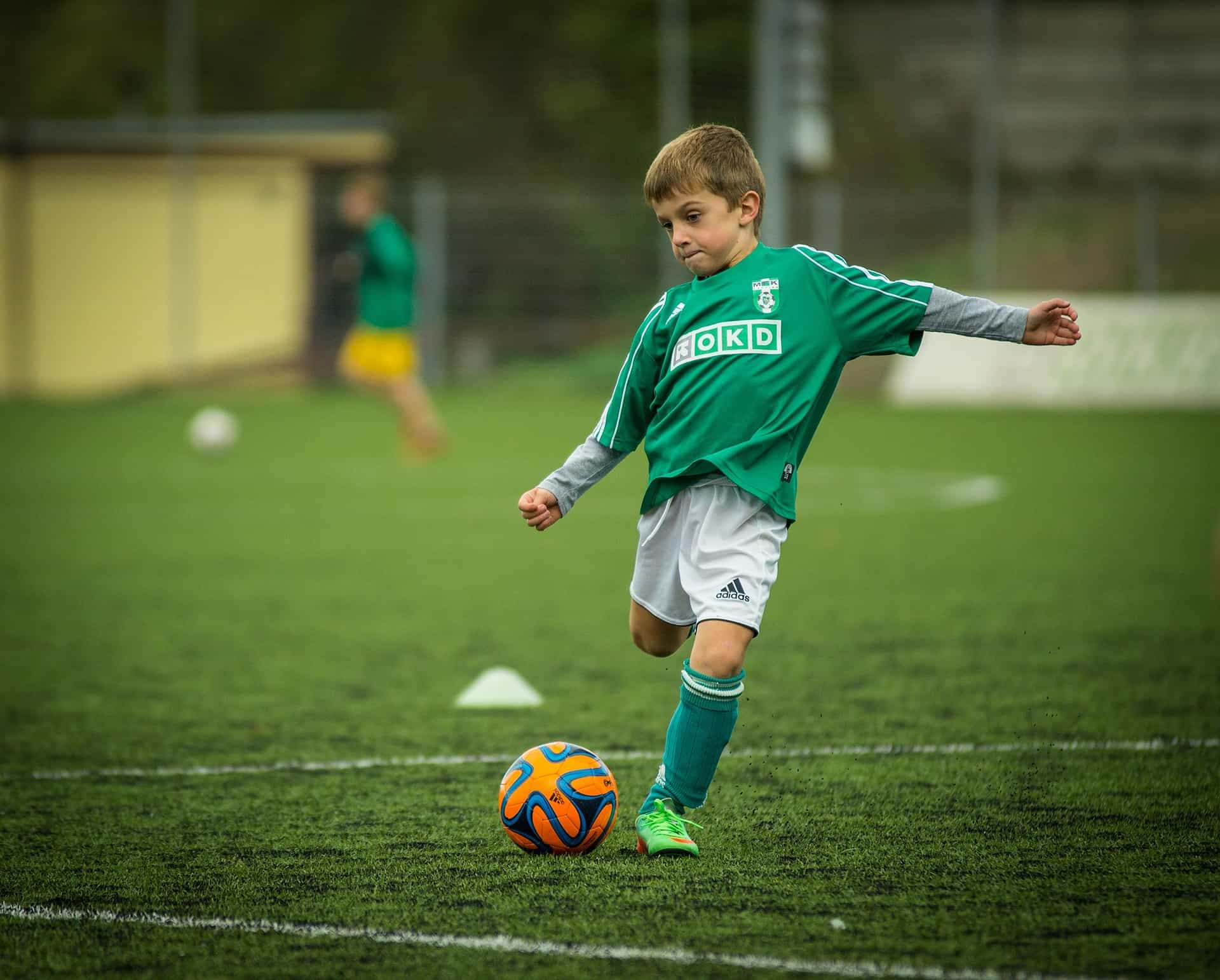 child playin football