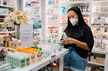 woman with face mask in pharmacy