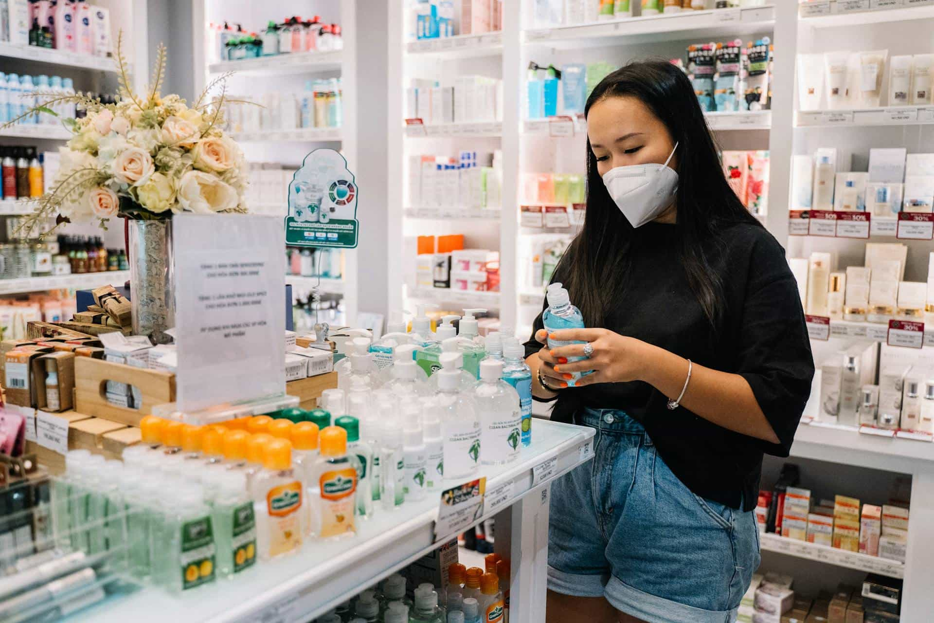 woman with face mask in pharmacy