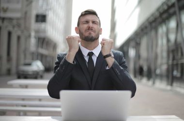 man in suit with laptop