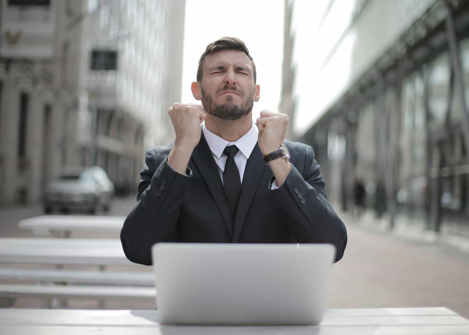 man in suit with laptop