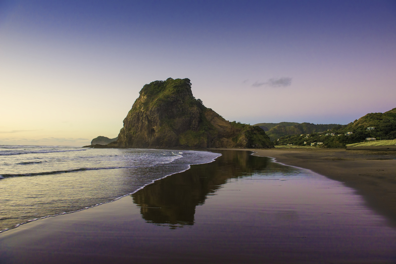 Lion Rock and Piha's famous black sand. Piha, New Zealand.