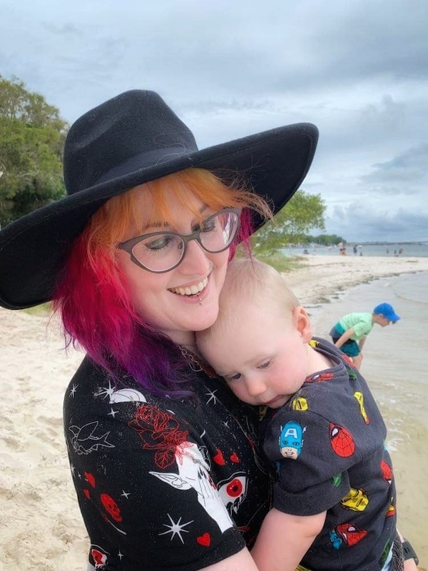 Mother and infant son on holiday at the beach