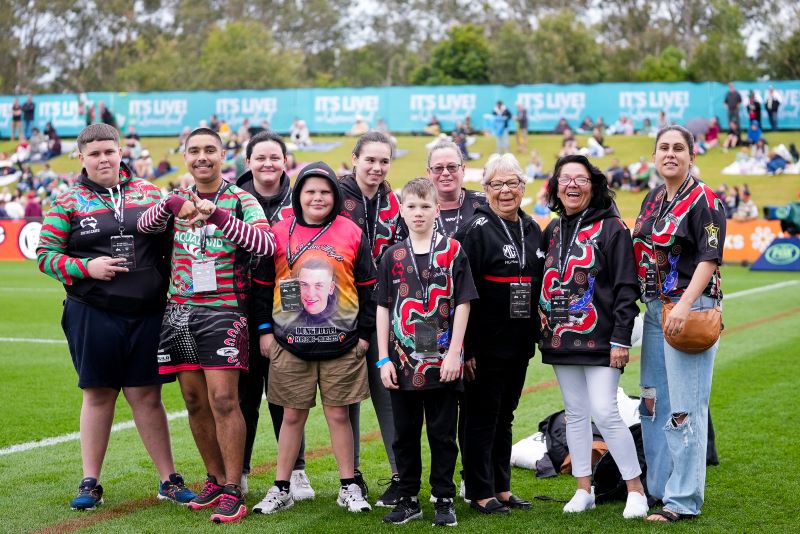 Souths cares program participants on field at Rabbitohs  game