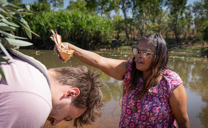 Kakadu Billabong Safari Camp experience - First Nations woman pouring water