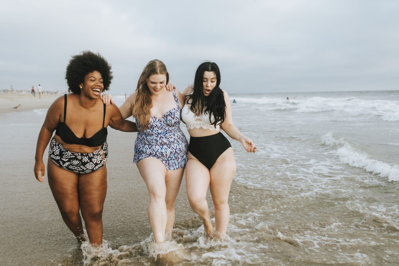 3 women walking along the beach