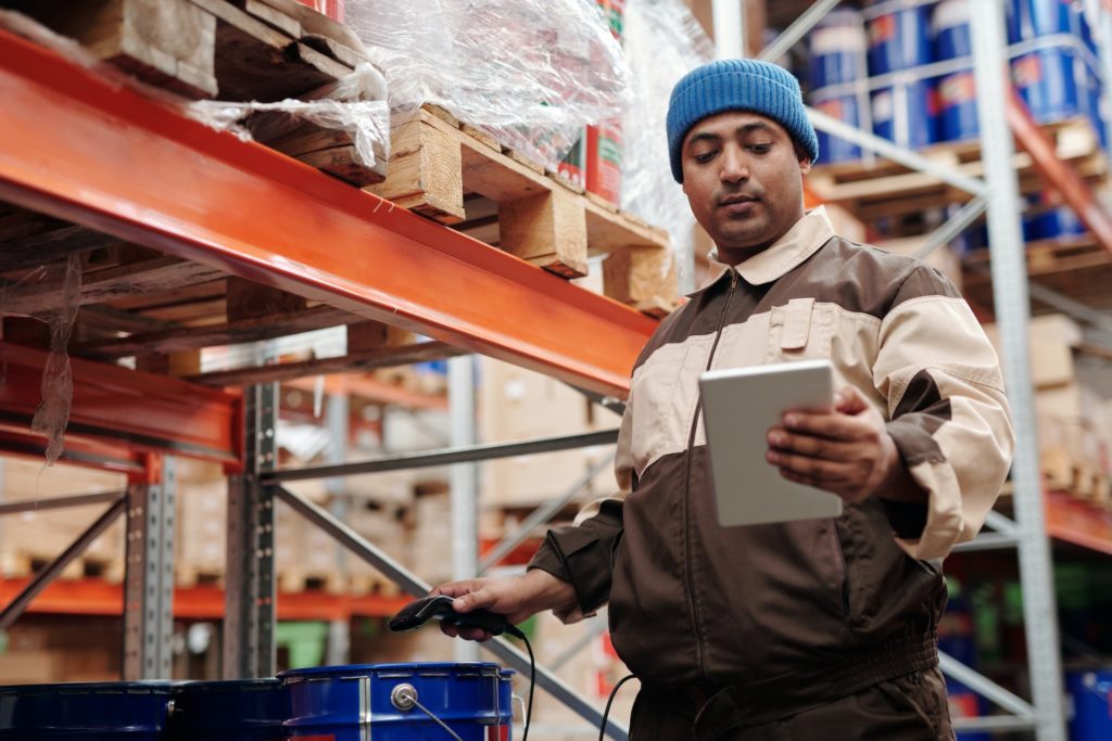 A warehouse employee scanning a product label 