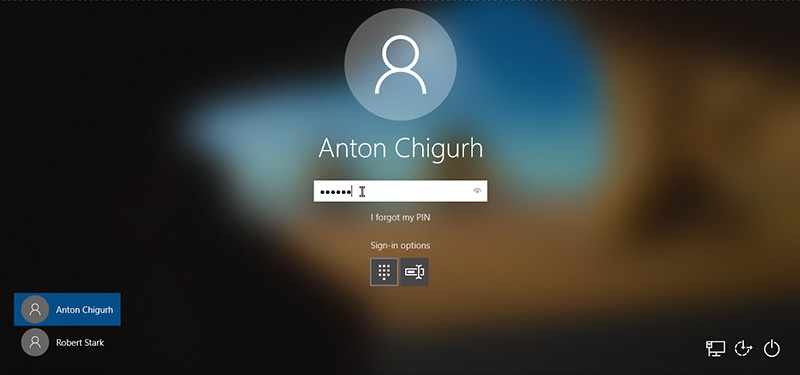 switch between Hello PIN and password by clicking the Sign-In Options on the sign-in screen