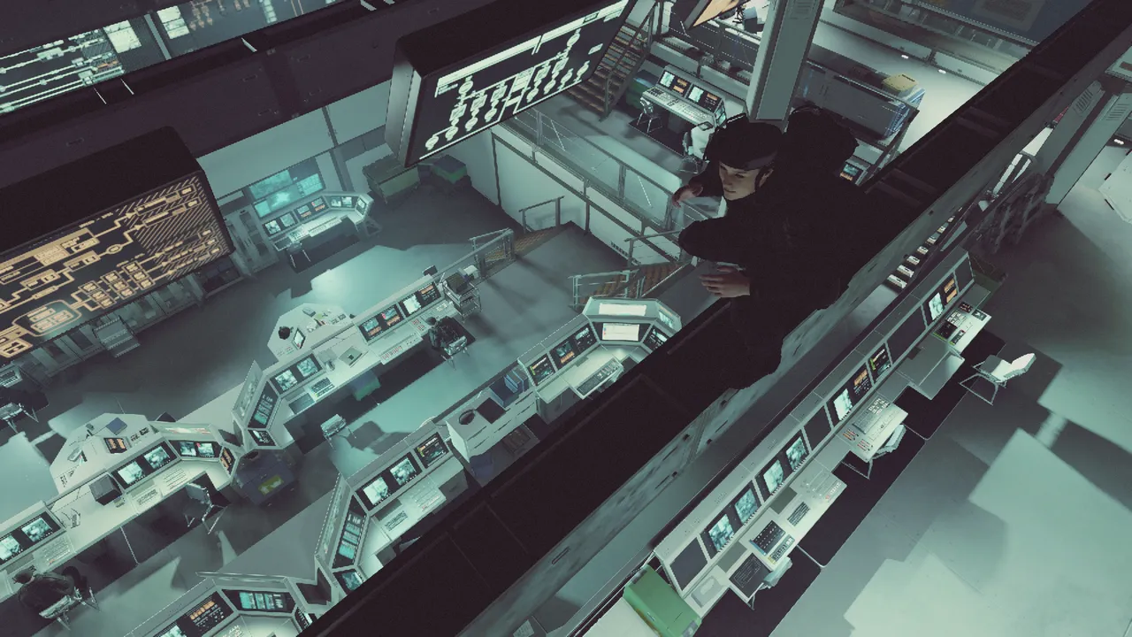 A woman in black sneaking along the top of a wall looking down into a command center of multi-screen work stations