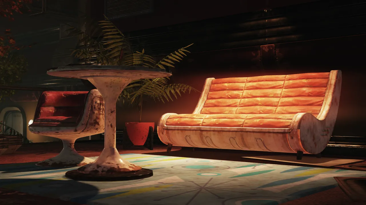 A mood-lit furniture set of a couch, chair, small table, and potted plant