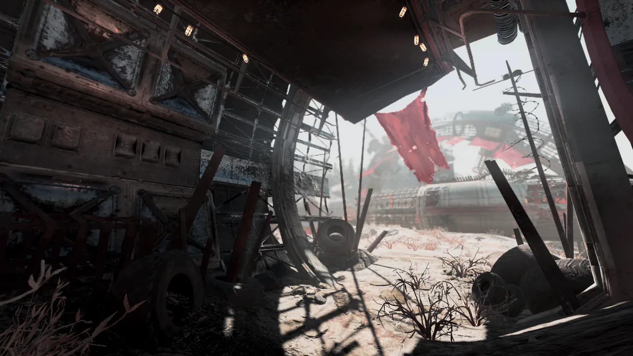 Looking out from under shelter of broken ruins. a red, tattered banner flaps in the wind