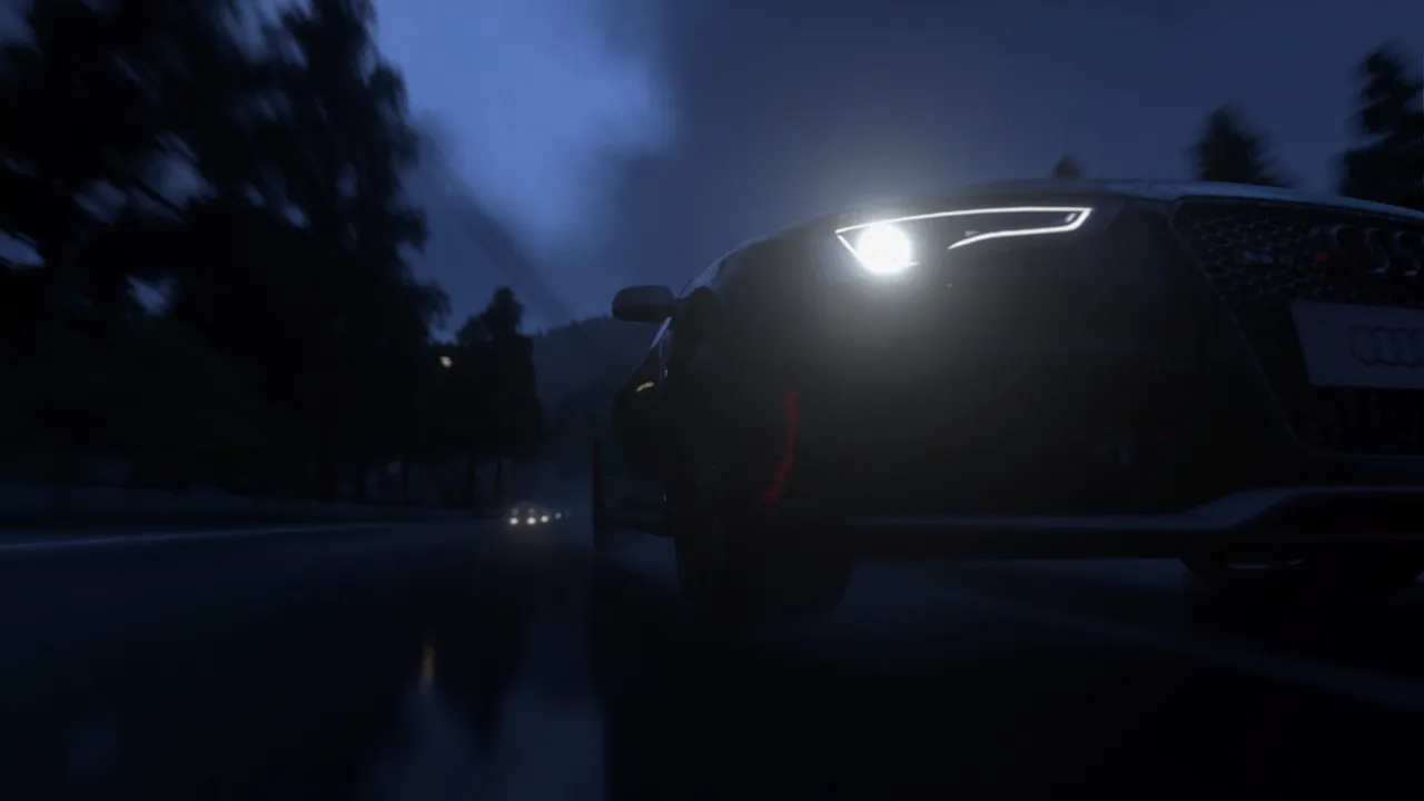 Audi leading a race on a wet, moonlit street.