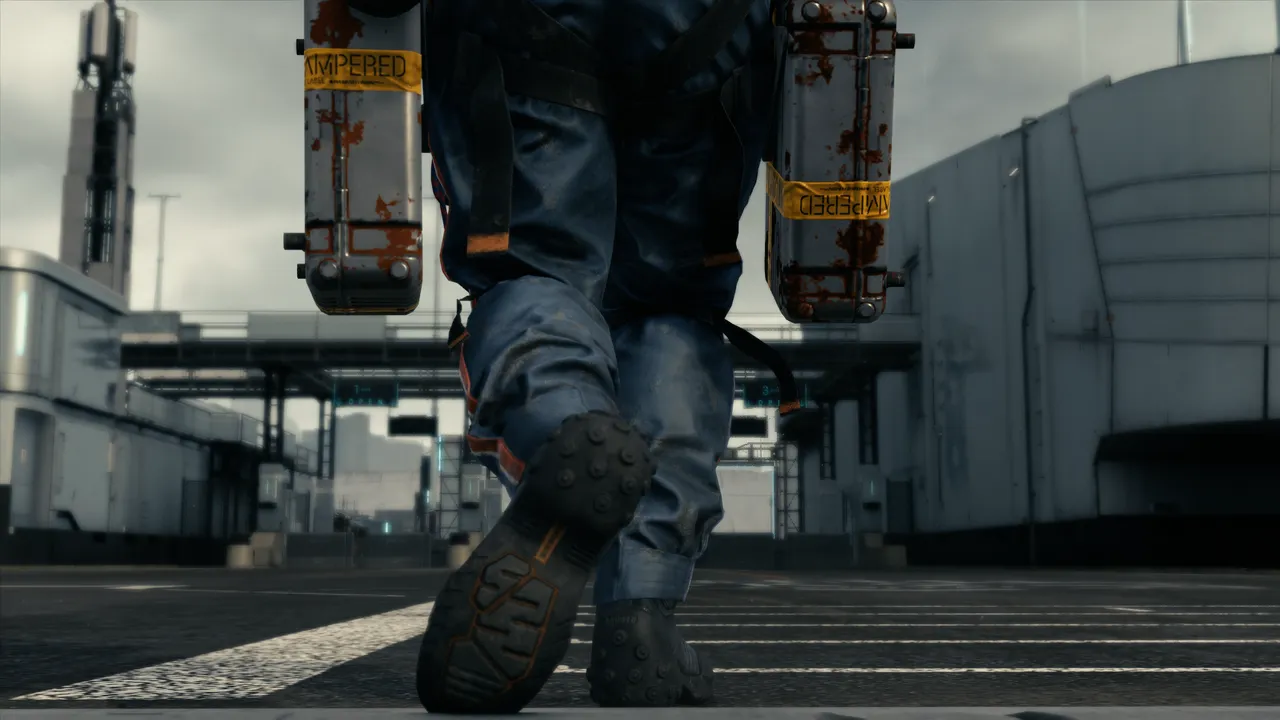 Close up of Sam Bridges feet as he walks to an outpost with parcels.