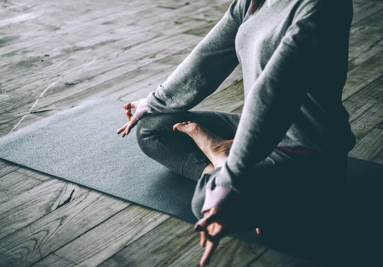 Young-Woman-Meditates-While-Practicing-Yoga.jpg