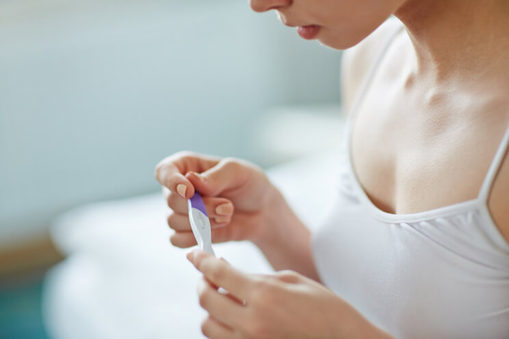 woman-looking-at-pregnancy-test.jpg