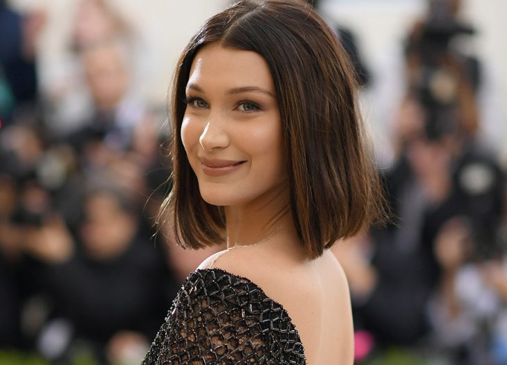 Chica de cabello corto, castaño y lacio con un vestido negro