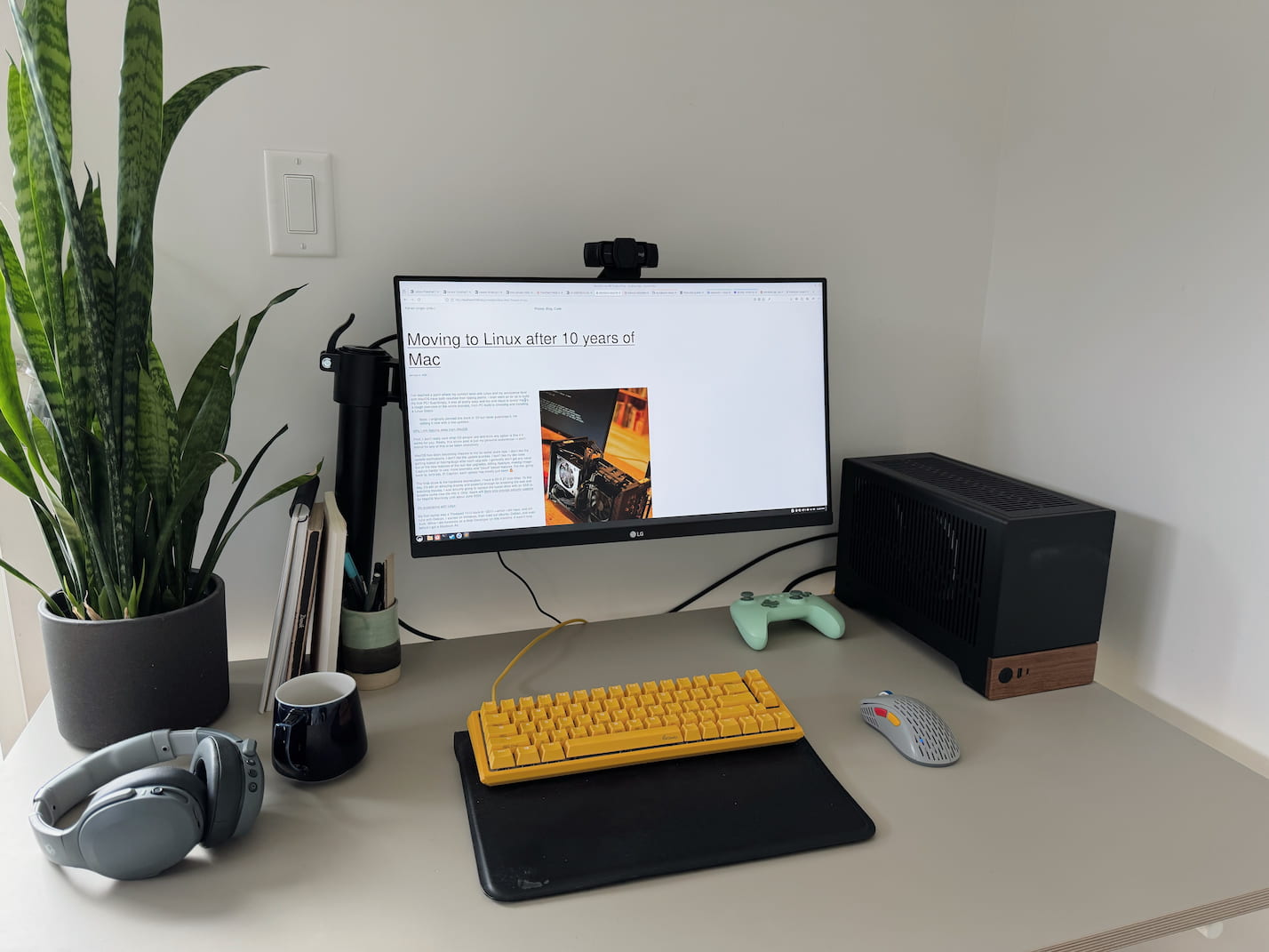 Photo of a custom built PC on a gray desk, complete with Ducky Yellow Keyboard, Mint Green Gaming Controller and a fun mouse with red, yellow and blue buttons.