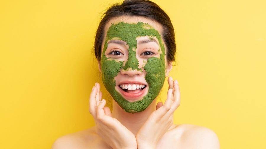 woman with green tea mask