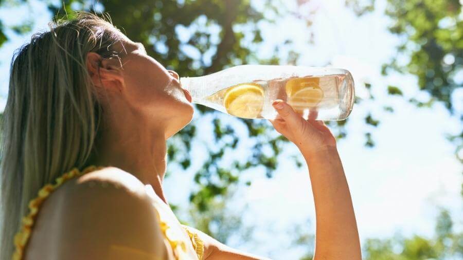 woman drinking lemon water