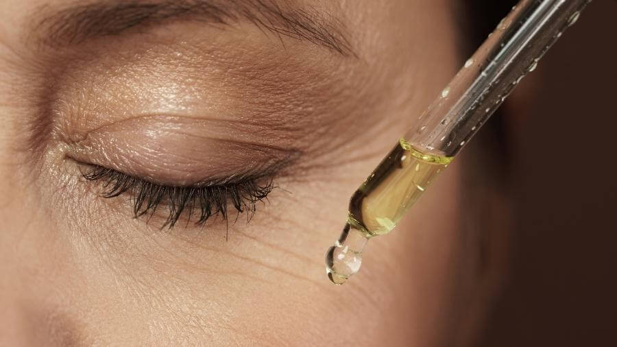 woman putting eye serum