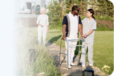 Clinicians walking with a patient outdoors