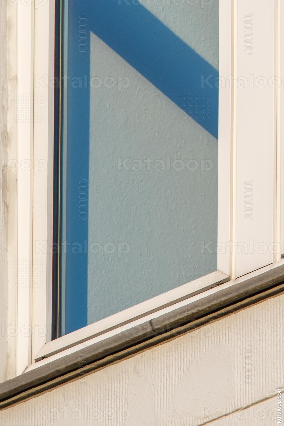 Abstract shadows on building facade with window