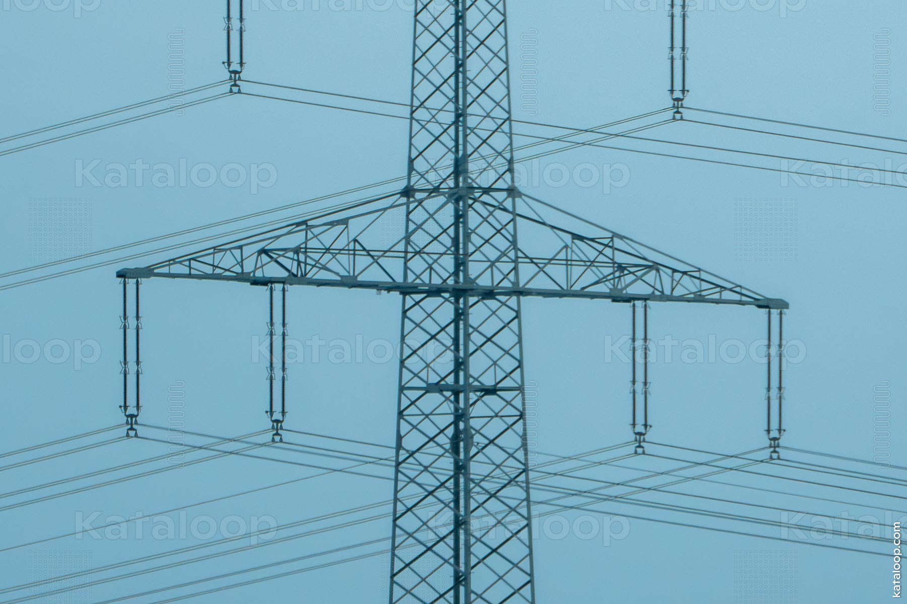 Symmetrical view of high voltage power lines and tower