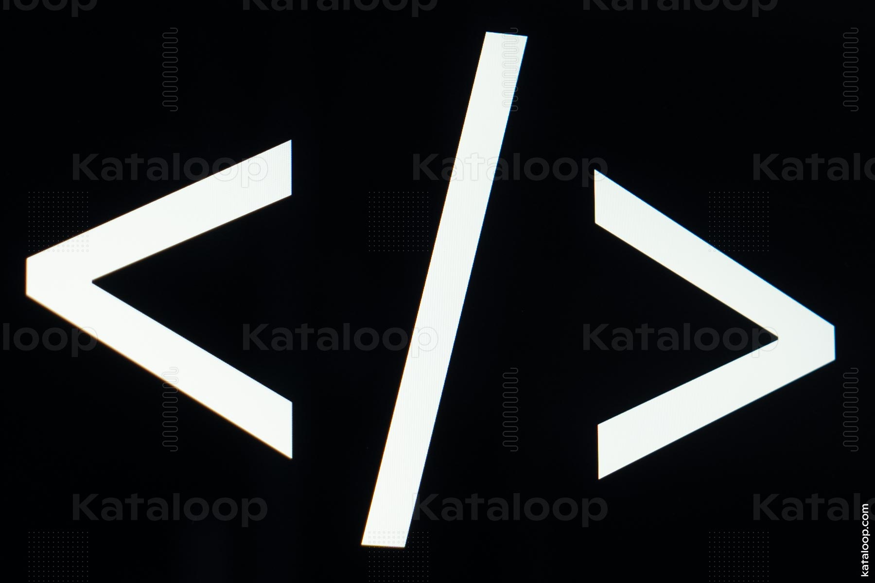 Laptop screen with coding brackets symbol on desk