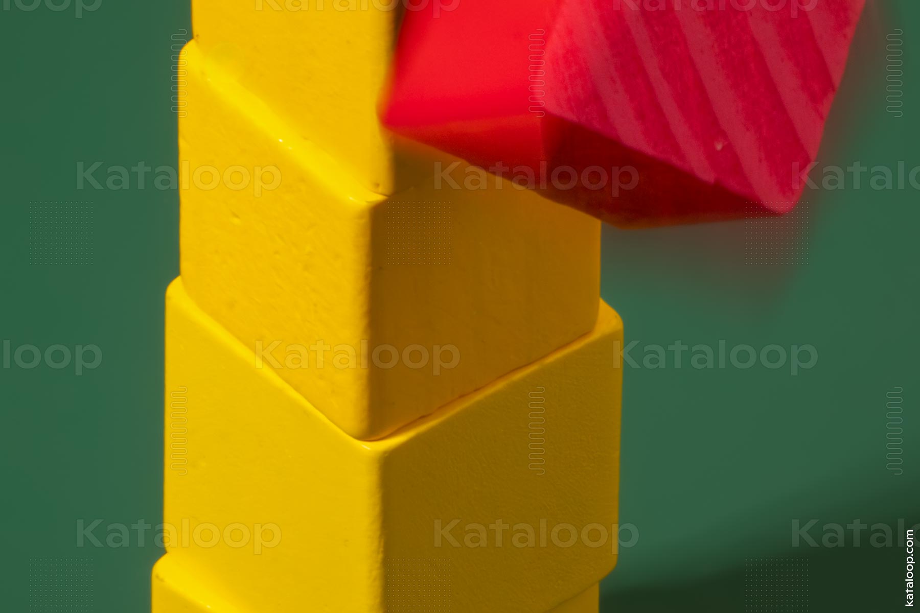 Abstract yellow blocks with red top on green background