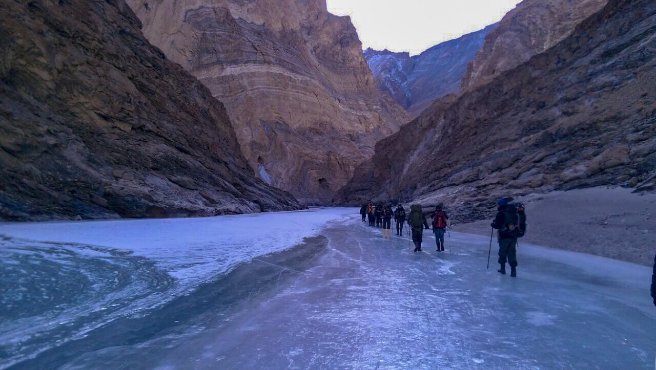 Trekkers crossing the frozen river