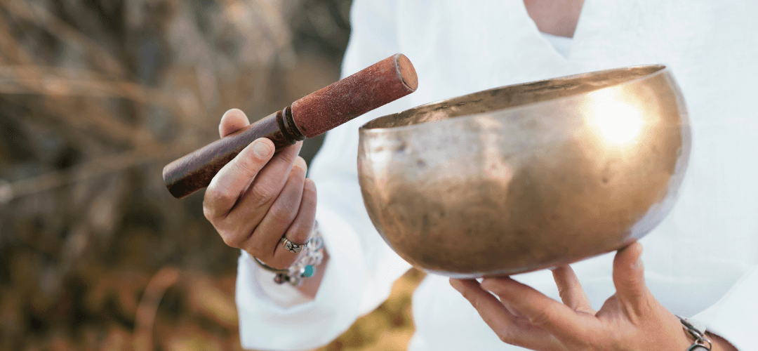 sound bath playlist a person holding a singing bowl