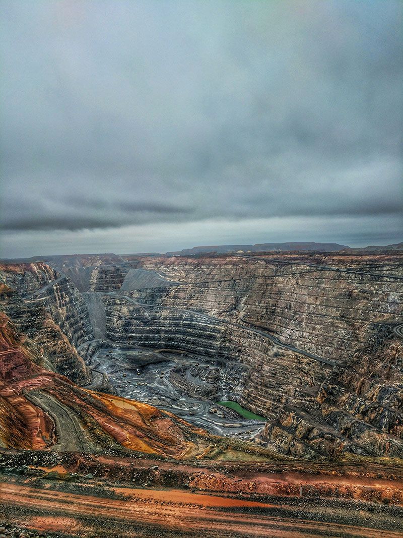 Former open pit mine in a gray and cloudy sky
