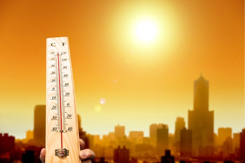 Thermometer showing very high temperature in a city