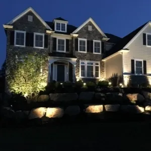 house lit up by landscape lighting