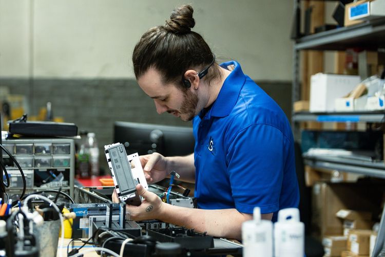 An MS Techz IT technician working on a computer
