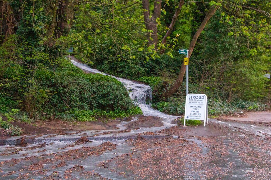 A burst water pipe is causing disruption around Stroud. Water from the burst pipe on the Stroud to Dudbridge cycle track cascading down towards Bath Road