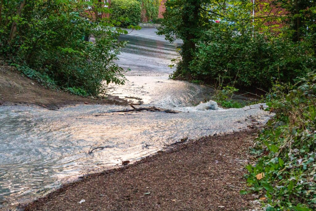 A burst water pipe is causing disruption around Stroud. Water from the burst pipe on the Stroud to Dudbridge cycle track cascading down towards Bath Road