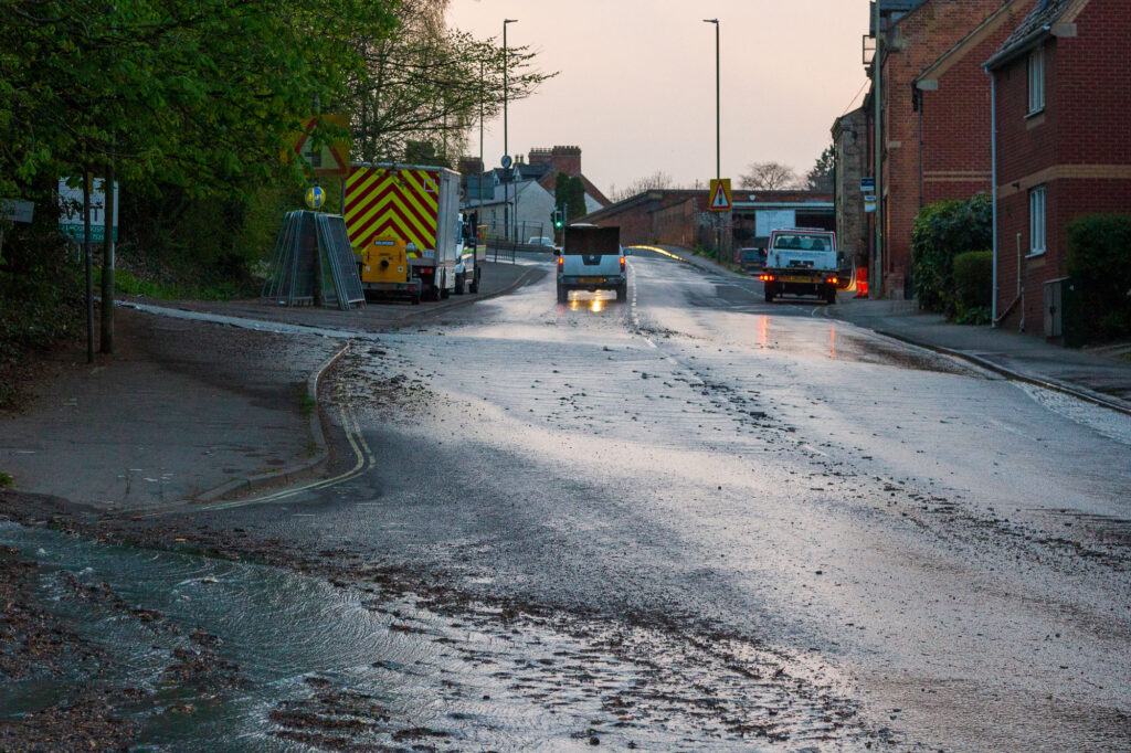 A burst water pipe is causing disruption around Stroud. Water from the burst pipe on Bath Road
