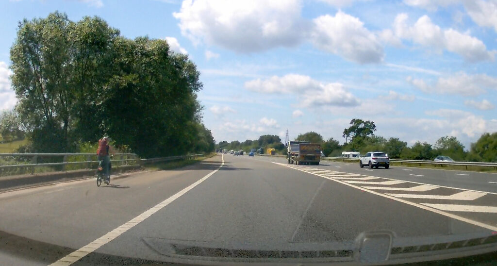 A startled motorist spotted a person cycling on the hard should of the M5 motorway this morning. Cyclist still | Caught on dashcam: cyclist riding on the M5 motorway