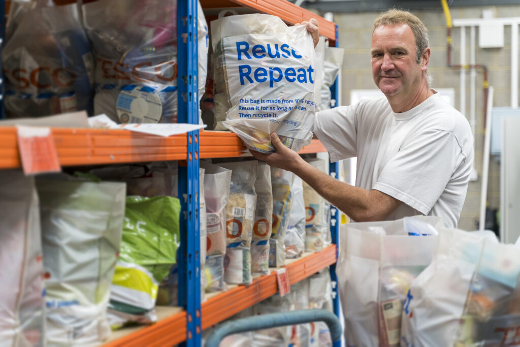 Stroud District Foodbank has a new operational base. Warehouse volunteer Peter Drover preparing bags of food at Stroud District Foodbank. Picture by Carl Hewlett / Hewlett Photography & Design