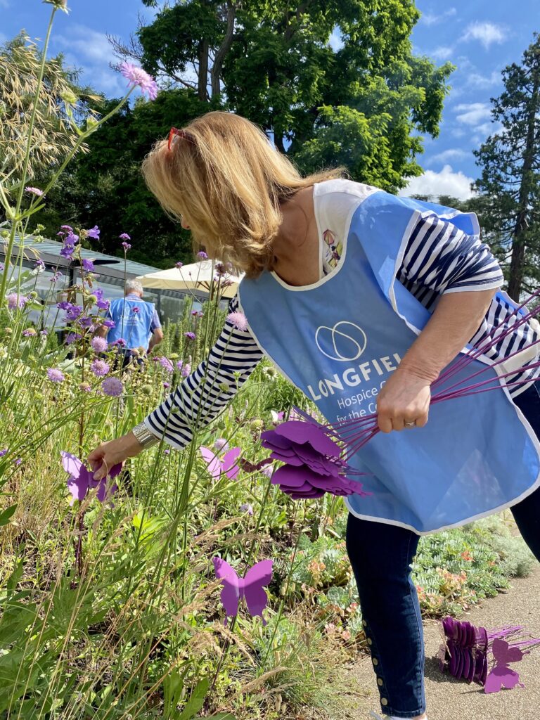One thousand butterflies have descended on Stroud. Hospice volunteer Wendy Taylor helps with the butterfly installation | One thousand butterflies land at the museum