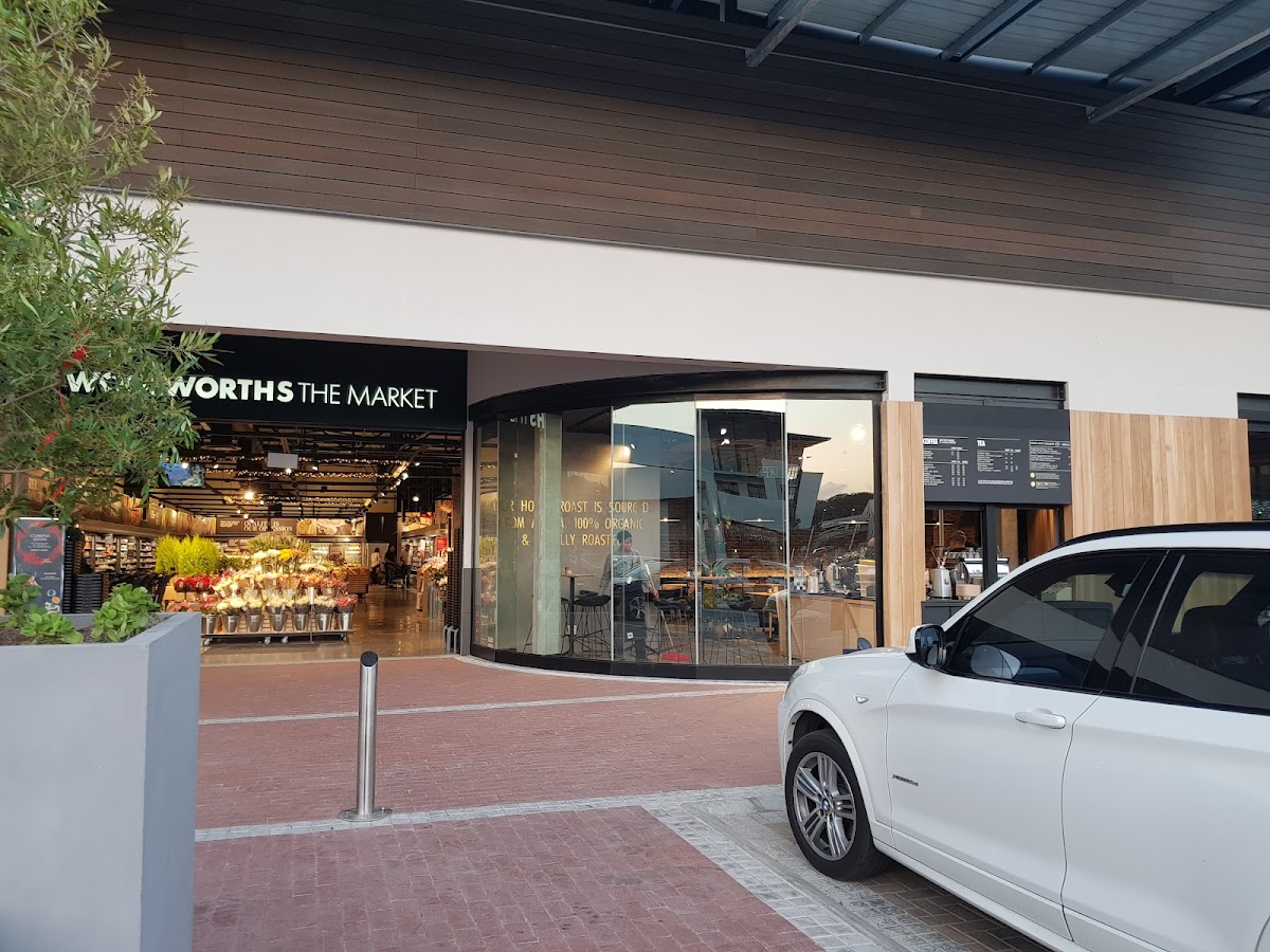 Woolworths Café Village Square logo