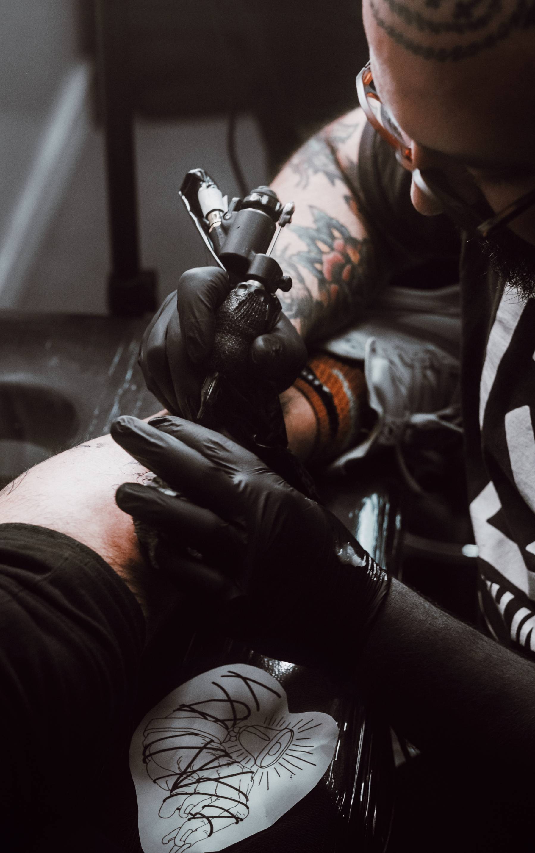 Person doing tattoo