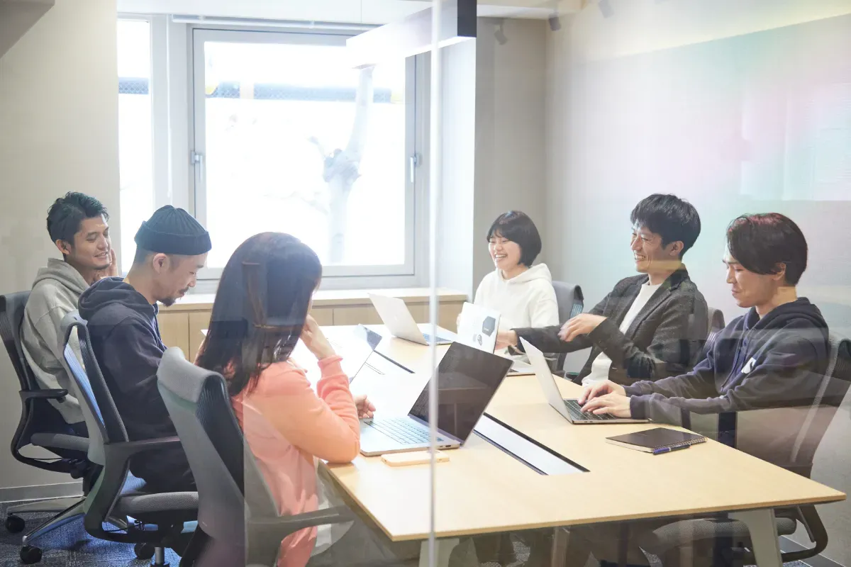 会社のオフィスで楽しそうに働く従業員たち
