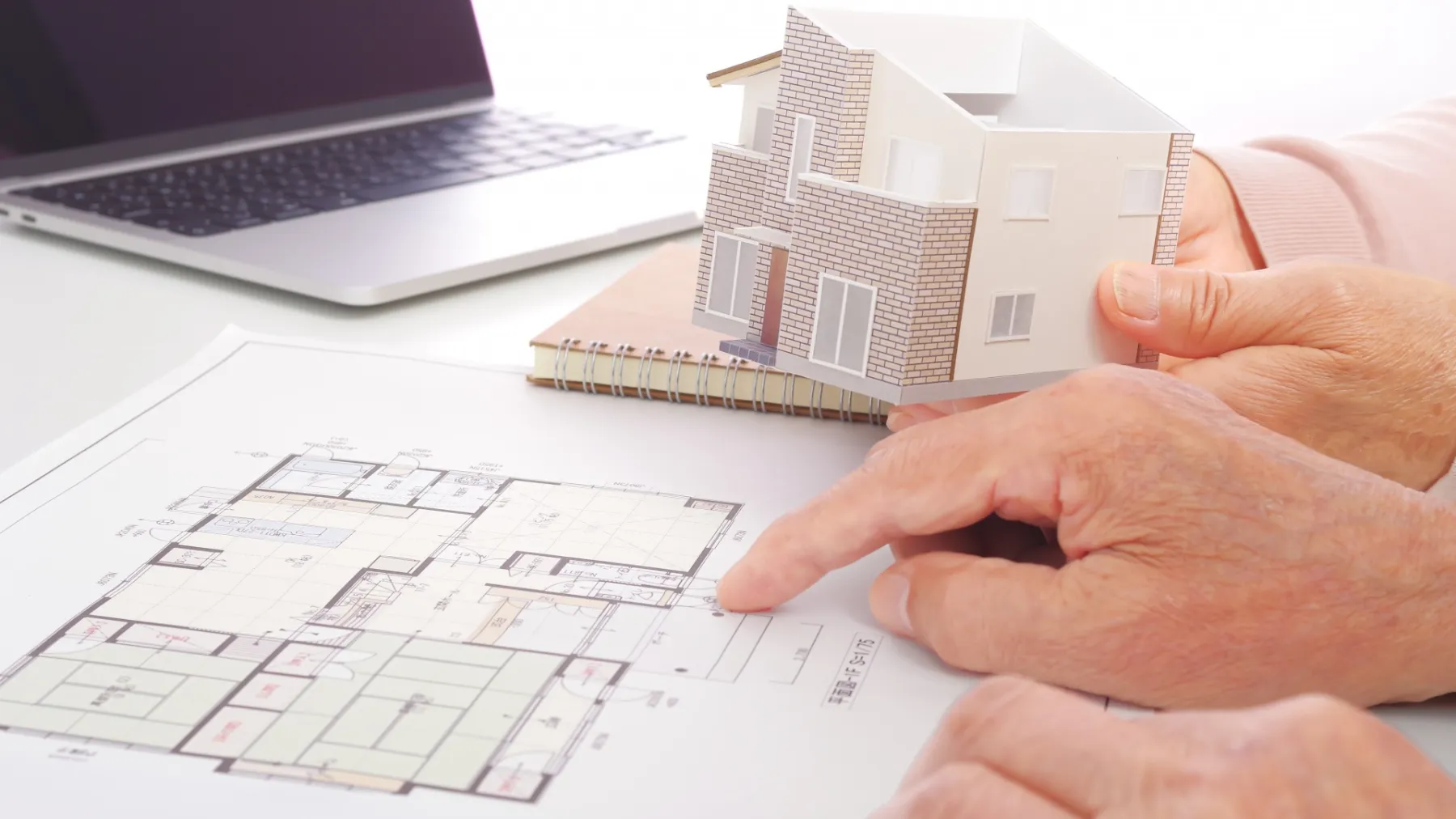 住宅の図面を見ながら検討をするシニア夫婦