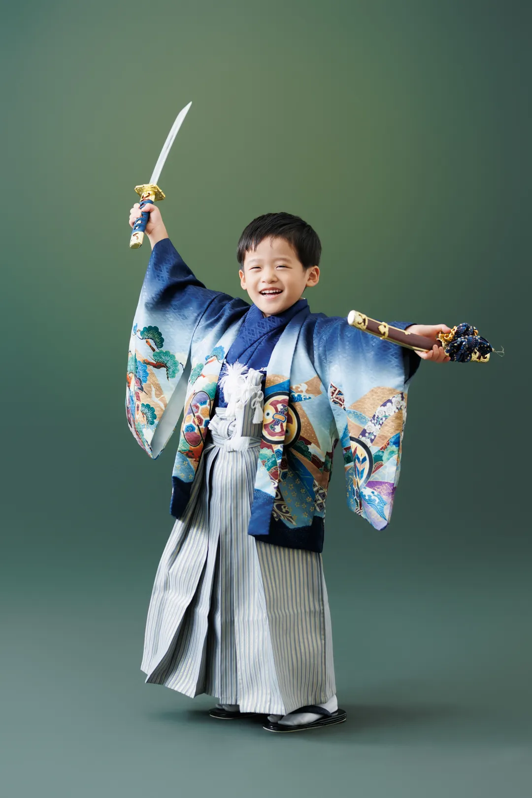 青い着物袴姿で刀を掲げるポーズをとる5歳男の子の七五三フォト(白山市)|ヤマダフォト
